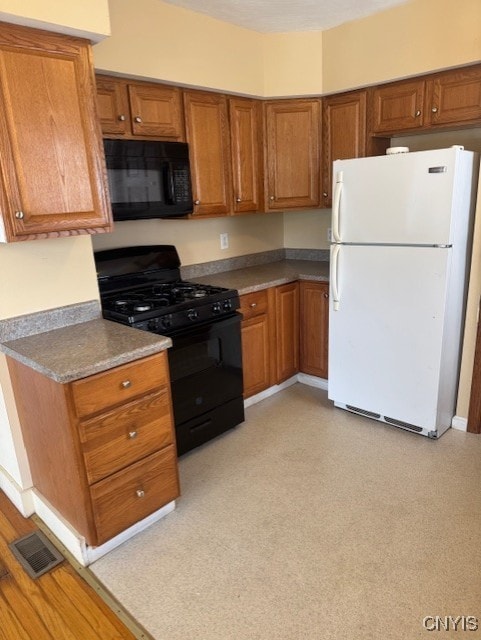 308 Wayland Rd, Salina, NY 13208 - kitchen featuring black appliances, brown cabinets, and light floors