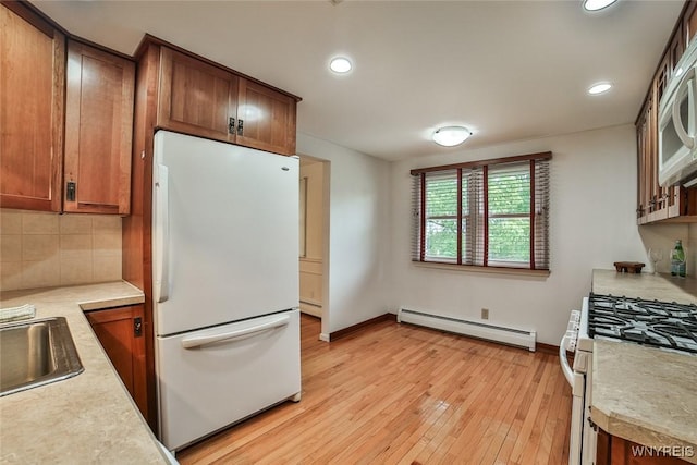 46 Macarthur Dr, Amherst, NY 14221 - kitchen with white appliances, baseboard heating, light countertops, light wood-style flooring, and recessed lighting