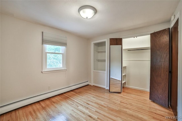 46 Macarthur Dr, Amherst, NY 14221 - unfurnished bedroom featuring a baseboard heating unit and light wood-type flooring