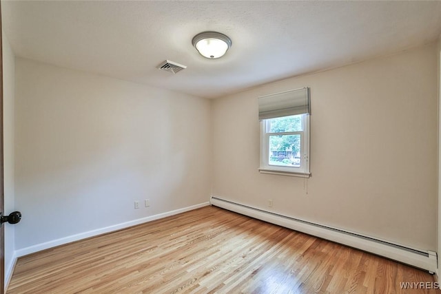 46 Macarthur Dr, Amherst, NY 14221 - unfurnished room with a baseboard radiator and wood finished floors