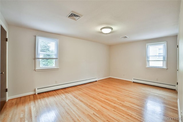 46 Macarthur Dr, Amherst, NY 14221 - unfurnished bedroom with a baseboard heating unit, multiple windows, and light wood-style flooring