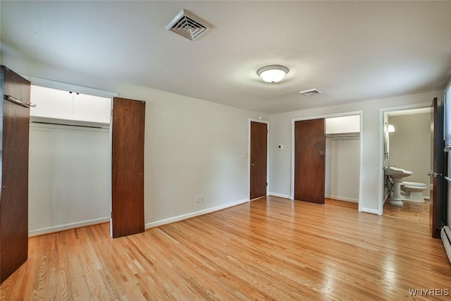 46 Macarthur Dr, Amherst, NY 14221 - unfurnished bedroom featuring light wood-style floors, ensuite bath, and baseboard heating