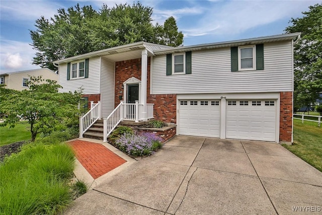 46 Macarthur Dr, Amherst, NY 14221 - bi-level home with brick siding, an attached garage, and driveway