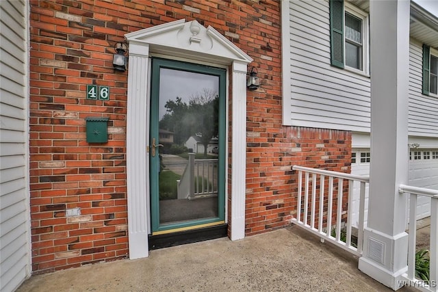 46 Macarthur Dr, Amherst, NY 14221 - entrance to property featuring brick siding and an attached garage