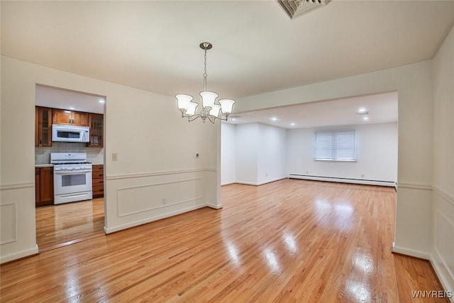 46 Macarthur Dr, Amherst, NY 14221 - empty room with a baseboard heating unit, light wood-type flooring, a chandelier, and recessed lighting