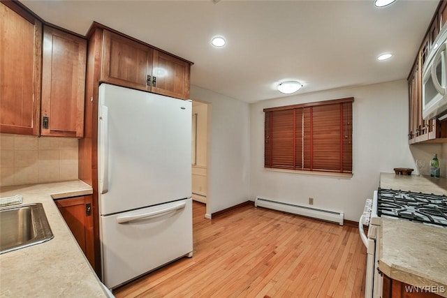 46 Macarthur Dr, Amherst, NY 14221 - kitchen featuring white appliances, baseboard heating, light countertops, recessed lighting, and light wood finished floors