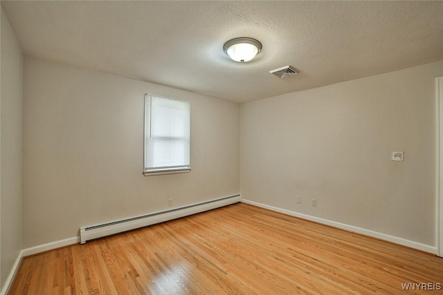 46 Macarthur Dr, Amherst, NY 14221 - spare room with a baseboard radiator, light wood-style floors, and a textured ceiling