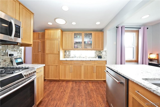 120 Cloverside Ct, West Seneca, NY 14224 - kitchen featuring appliances with stainless steel finishes, decorative backsplash, dark wood-style flooring, glass insert cabinets, and light stone counters