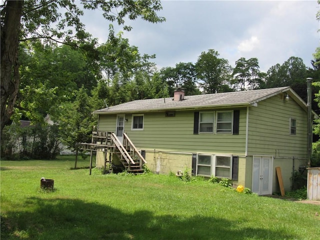 18 Mark Cir, Naples, NY 14512 - rear view of property featuring a yard, stairs, a chimney, a deck, and view of scattered trees