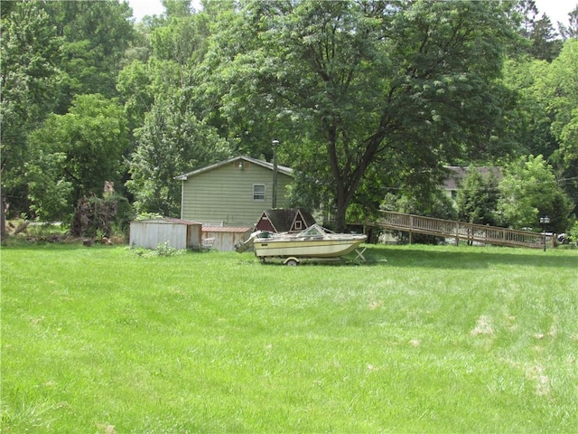 18 Mark Cir, Naples, NY 14512 - view of green lawn featuring a wooded view
