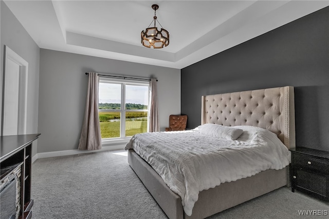 6993 Pine Lk, Pendleton, NY 14120 - carpeted bedroom featuring a chandelier and a tray ceiling