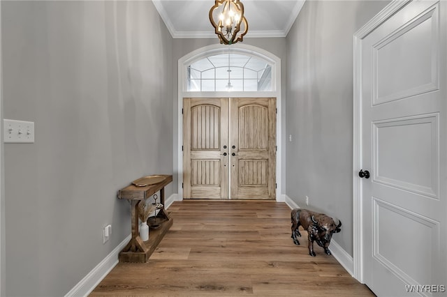 6993 Pine Lk, Pendleton, NY 14120 - entrance foyer featuring a chandelier, crown molding, and wood finished floors
