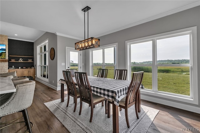 6993 Pine Lk, Pendleton, NY 14120 - dining area with healthy amount of natural light, crown molding, a chandelier, dark wood-style flooring, and recessed lighting