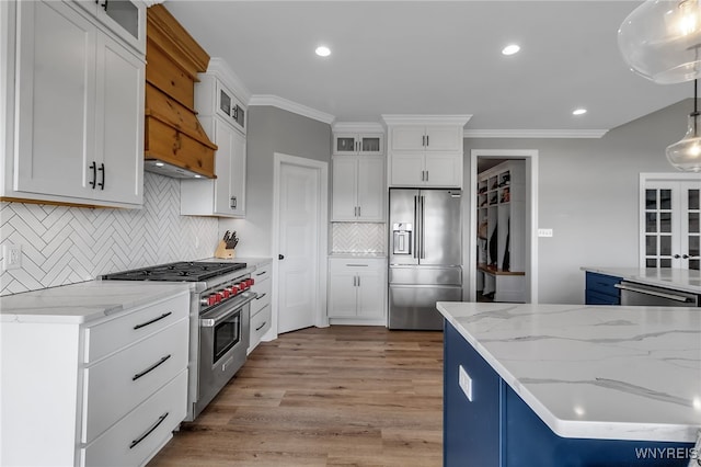 6993 Pine Lk, Pendleton, NY 14120 - kitchen featuring high quality appliances, light wood finished floors, custom range hood, crown molding, and white cabinetry