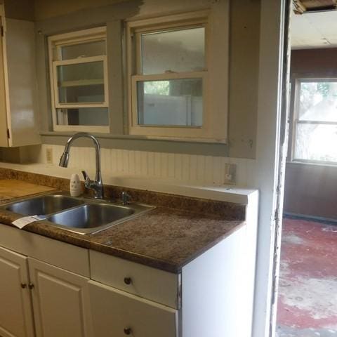 13 E Albion St, Murray, NY 14470 - kitchen with white cabinetry, dark countertops, and glass insert cabinets