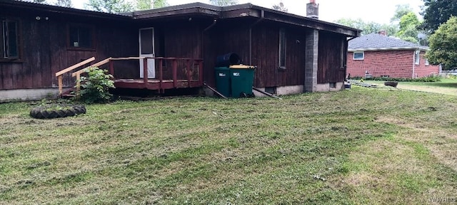 8567 Fairview Ter, Colden, NY 14033 - view of side of property with a lawn, a chimney, and a wooden deck