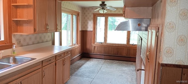 8567 Fairview Ter, Colden, NY 14033 - kitchen with wall chimney range hood, open shelves, wallpapered walls, a wainscoted wall, and a ceiling fan