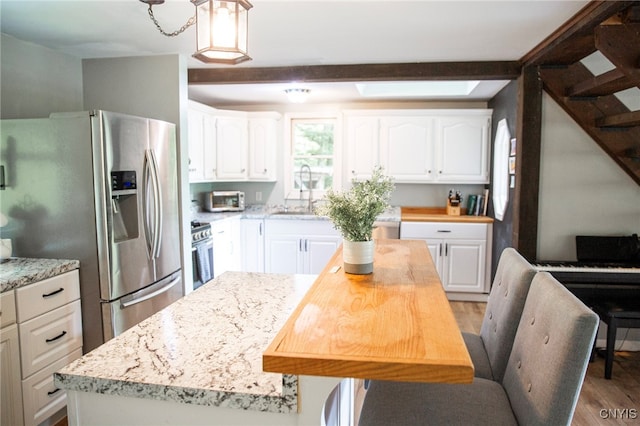 1346 Otisco Valley Rd, Otisco, NY 13110 - kitchen featuring appliances with stainless steel finishes, white cabinets, light wood-style flooring, decorative light fixtures, and light stone counters