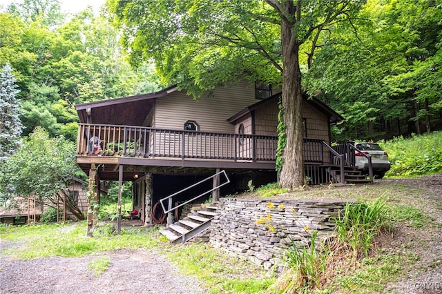 1346 Otisco Valley Rd, Otisco, NY 13110 - view of front of home featuring a deck, stairs, and a view of trees