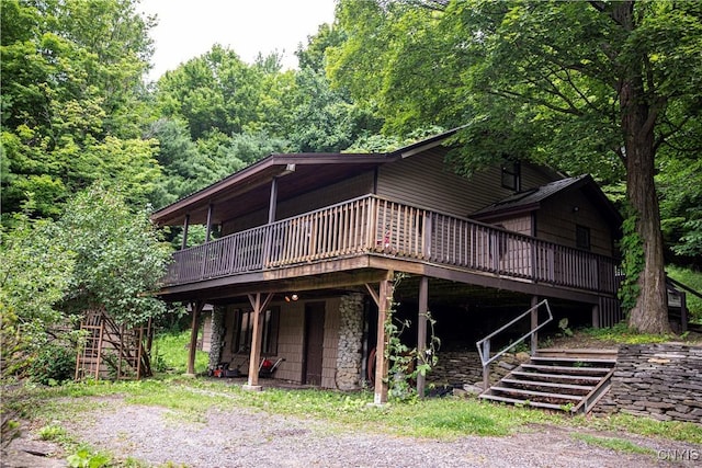 1346 Otisco Valley Rd, Otisco, NY 13110 - view of front of property featuring a deck, stone siding, and stairway