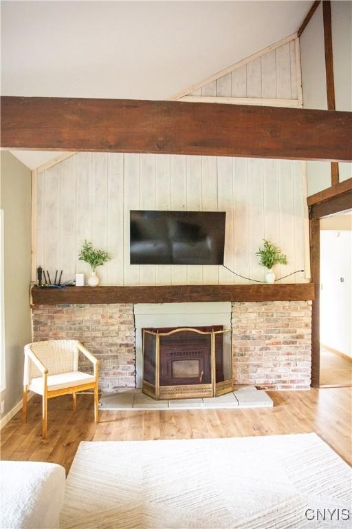 1346 Otisco Valley Rd, Otisco, NY 13110 - living room with wood finished floors, wood walls, and a fireplace