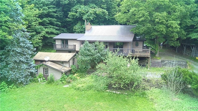 1346 Otisco Valley Rd, Otisco, NY 13110 - back of house featuring a chimney, a metal roof, and a forest view