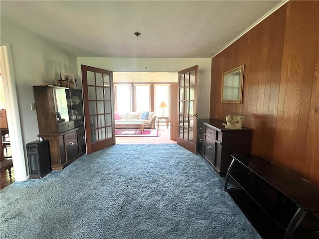 2 Maple Rd, Big Flats, NY 14845 - living area featuring french doors, carpet floors, and wood walls