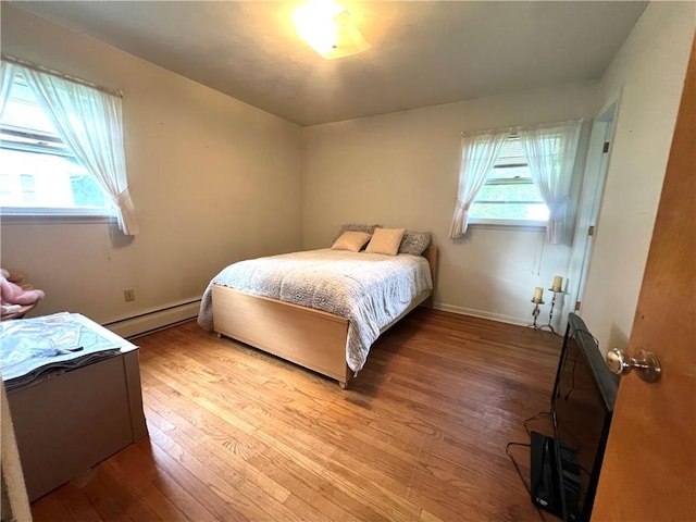 2 Maple Rd, Big Flats, NY 14845 - bedroom with baseboard heating and hardwood / wood-style flooring