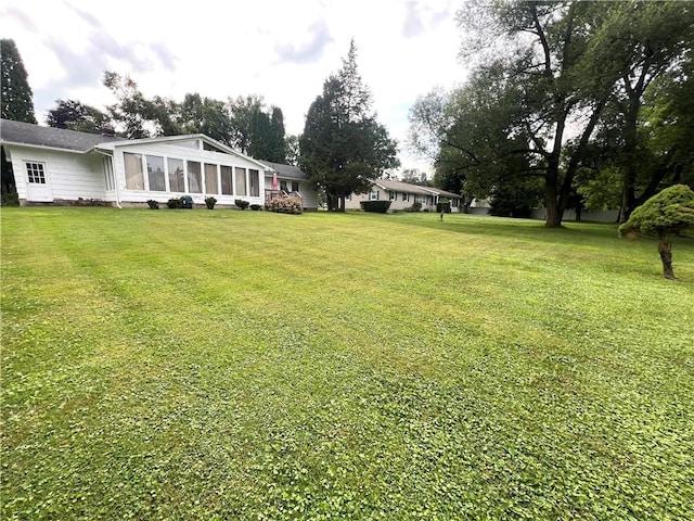 2 Maple Rd, Big Flats, NY 14845 - view of grassy yard with a sunroom
