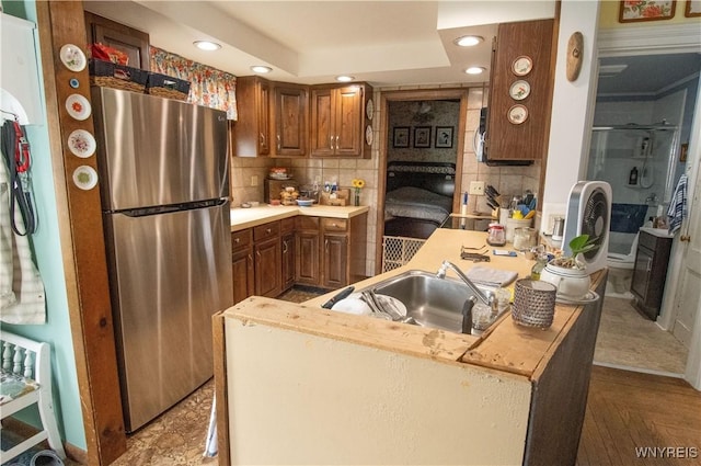14 W Main St, Concord, NY 14141 - kitchen featuring freestanding refrigerator, decorative backsplash, recessed lighting, light countertops, and brown cabinets
