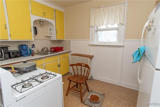 14 W Main St, Concord, NY 14141 - kitchen featuring white appliances, light countertops, wainscoting, radiator, and light floors