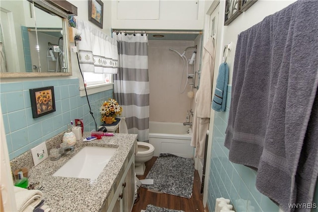 14 W Main St, Concord, NY 14141 - bathroom with tile walls, vanity, shower / bath combo with shower curtain, and wood finished floors