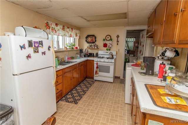 14 W Main St, Concord, NY 14141 - kitchen with white appliances, a paneled ceiling, light countertops, and brown cabinetry