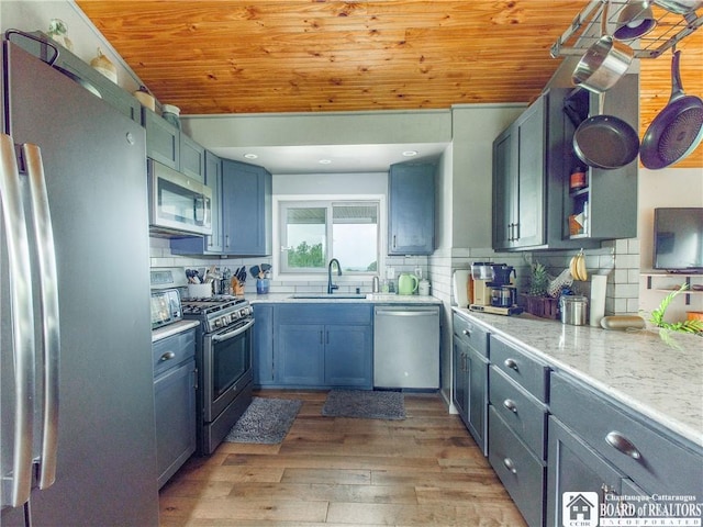 8800 Harmon Hill Rd, Pomfret, NY 14063 - kitchen featuring appliances with stainless steel finishes, wooden ceiling, light wood-style floors, tasteful backsplash, and light stone countertops