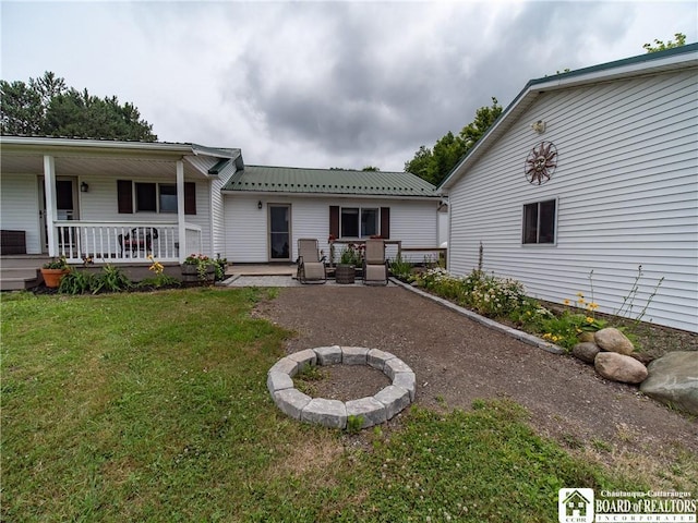 8800 Harmon Hill Rd, Pomfret, NY 14063 - back of house featuring a yard, a porch, and a metal roof
