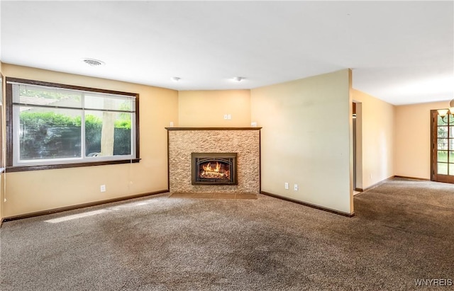 26 Farber Ln, Amherst, NY 14221 - unfurnished living room with carpet and a fireplace with flush hearth