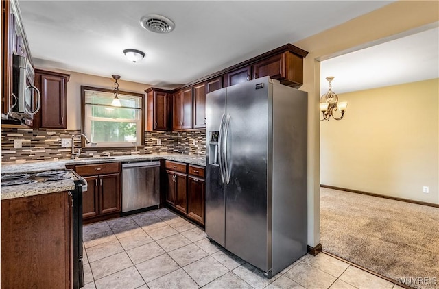26 Farber Ln, Amherst, NY 14221 - kitchen with appliances with stainless steel finishes, light tile patterned floors, tasteful backsplash, and a chandelier
