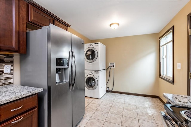 26 Farber Ln, Amherst, NY 14221 - laundry area with stacked washer / drying machine and light tile patterned flooring