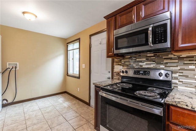 26 Farber Ln, Amherst, NY 14221 - kitchen with stainless steel appliances, tasteful backsplash, light stone countertops, and light tile patterned floors