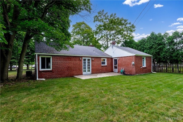 26 Farber Ln, Amherst, NY 14221 - rear view of house featuring a patio area, french doors, brick siding, and a chimney