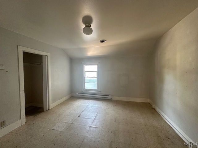 85 W Clark St, German Flatts, NY 13357 - empty room featuring a baseboard radiator, light flooring, and vaulted ceiling