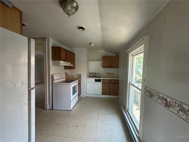 85 W Clark St, German Flatts, NY 13357 - kitchen with white appliances, under cabinet range hood, lofted ceiling, light floors, and brown cabinets