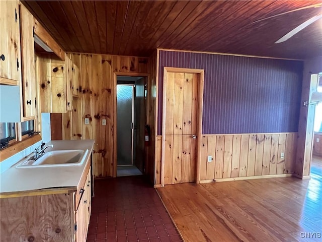 8227 Catfish Point Rd, Cape Vincent, NY 13624 - kitchen featuring wood walls, wood ceiling, dark wood-style floors, and light countertops