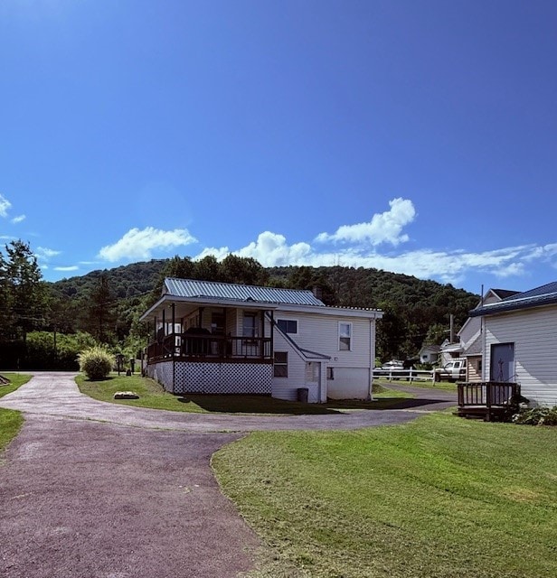 6113 Rte 46, Keating Town, PA 16749 - view of front of home featuring a front lawn, a metal roof, asphalt driveway, and a mountain view
