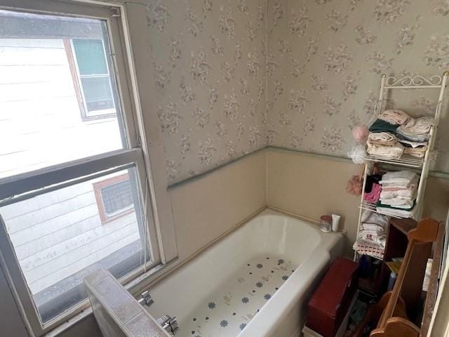 67 Perry Ave, Corning City, NY 14830 - bathroom with wallpapered walls, a bathtub, and wainscoting