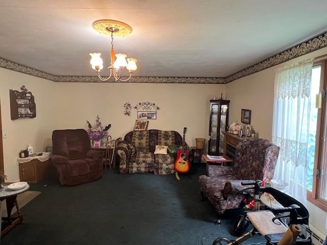 67 Perry Ave, Corning City, NY 14830 - living room with a chandelier, healthy amount of natural light, and carpet floors