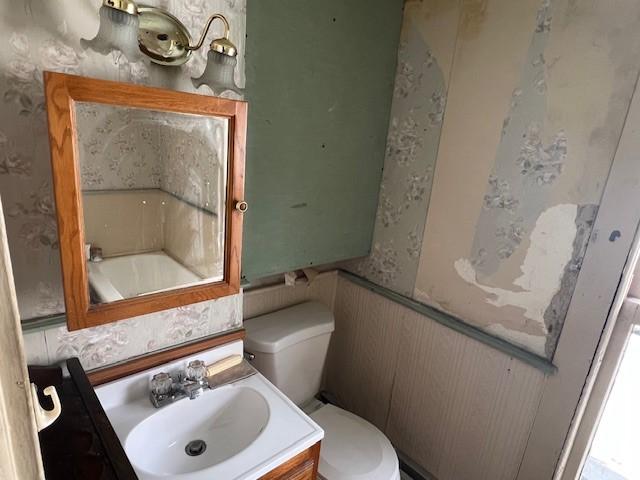 67 Perry Ave, Corning City, NY 14830 - bathroom featuring vanity, wallpapered walls, and a bath