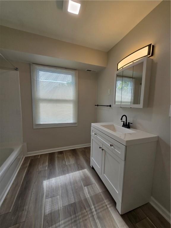 2381 Culver Rd, Irondequoit, NY 14609 - full bath with vanity, plenty of natural light, and wood finished floors