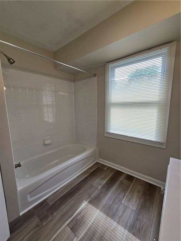 2381 Culver Rd, Irondequoit, NY 14609 - bathroom featuring shower / bathtub combination and wood finished floors