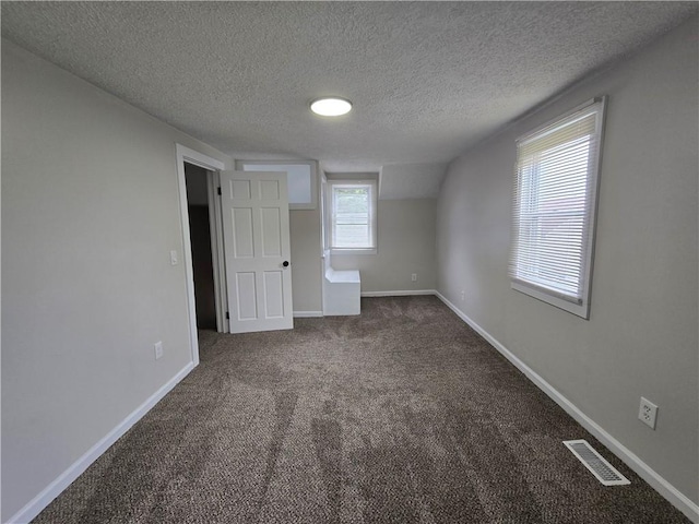 2381 Culver Rd, Irondequoit, NY 14609 - unfurnished bedroom featuring dark colored carpet and a textured ceiling
